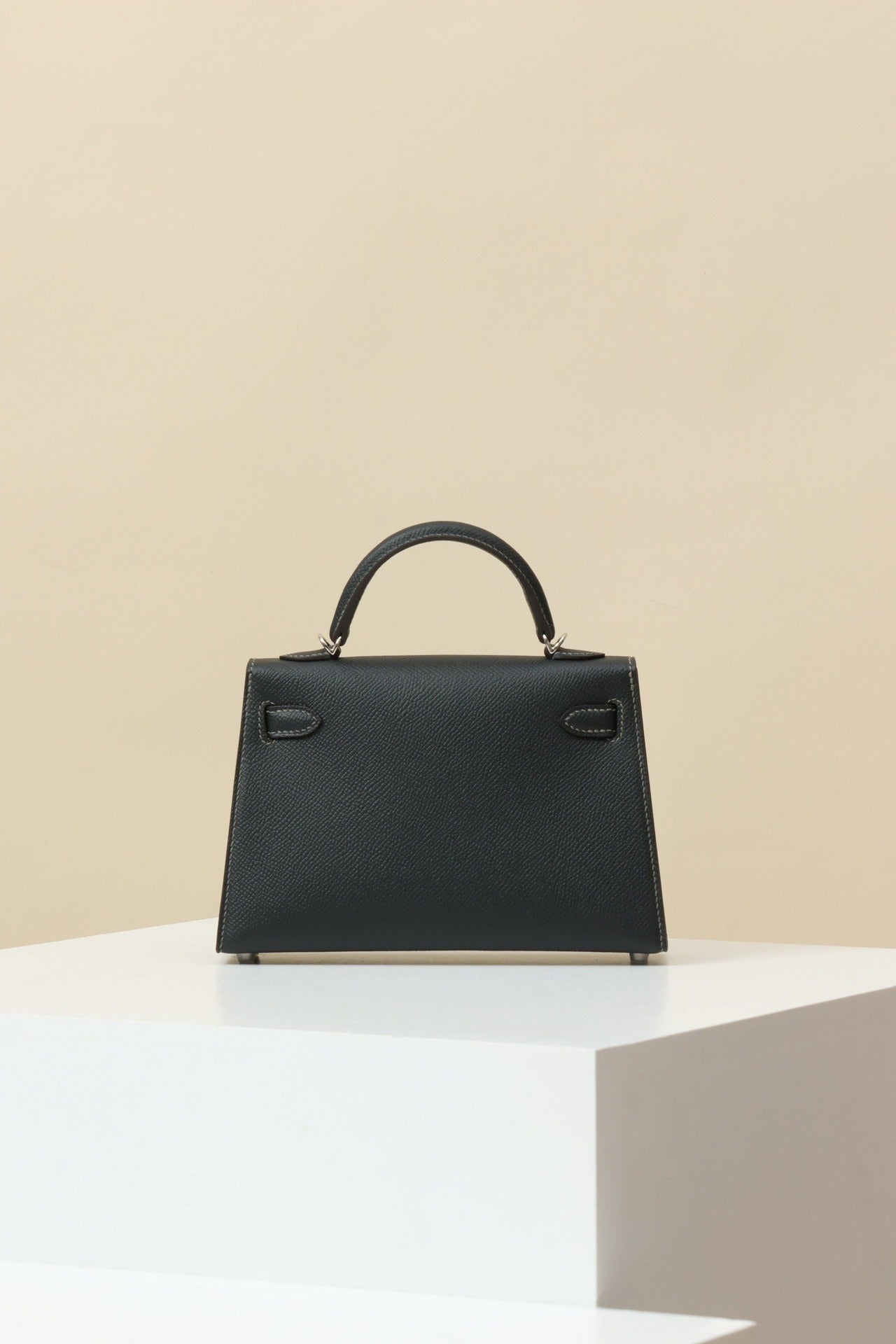 Mini Leather Elegance by Lorvien Maison – Luxury Women’s Handbag in sleek black design on a white pedestal.